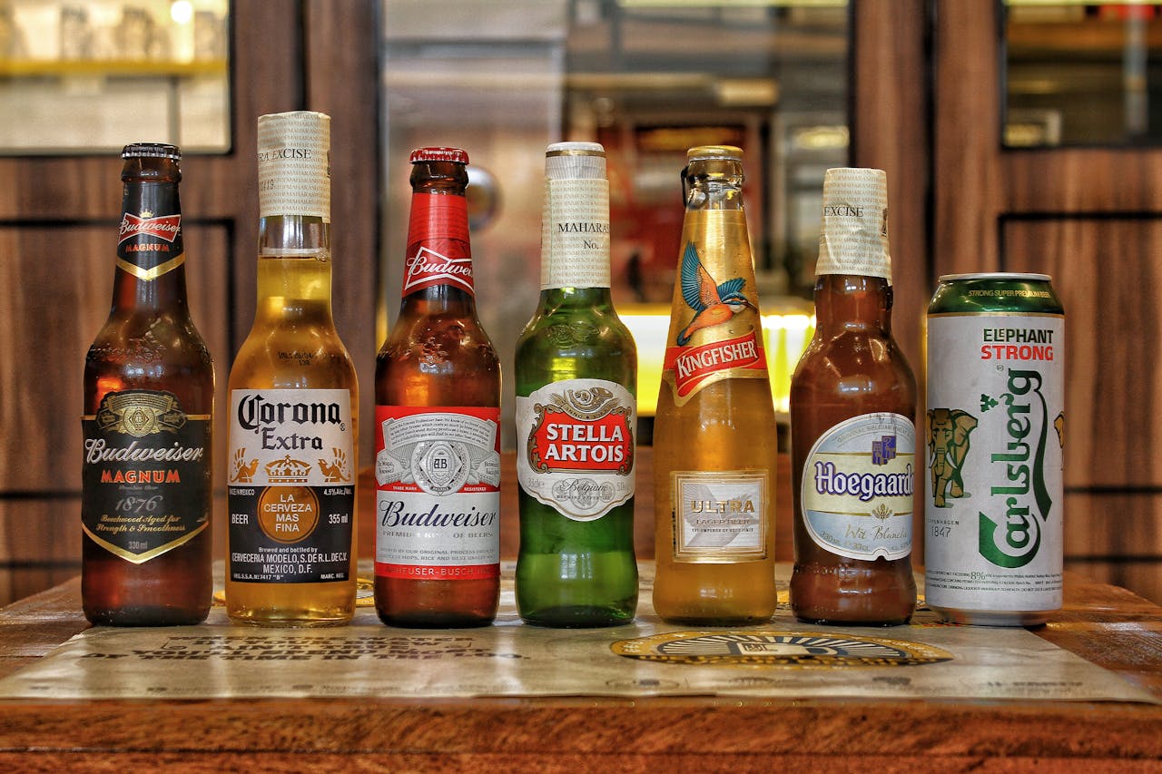 Collection of international beer bottles displayed on a bar counter.